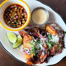 Johnny Sanchez signature dishes Al Pastor TacosShort Rib BirriaAdios Burger